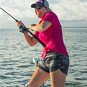 Famale angler fighting a fish