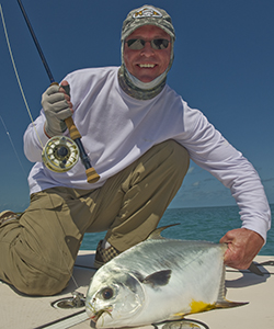 fly fishing flats for permit. Angler shows off his permit